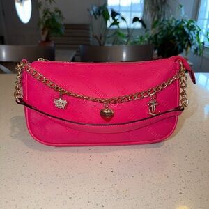 Juicy Couture "Not Your Babe" shoulder bag in the Pink Flash color.